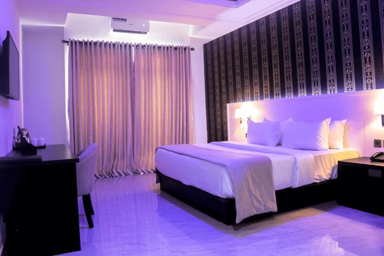 Modern meeting room at BON Hotel Ikeja Residence with desk, ideal for business events and seminars.
