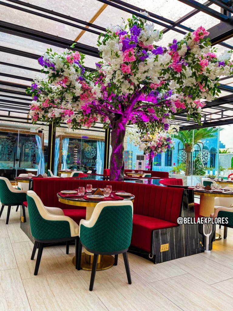 Vibrant floral event space with tiered seating, perfect for brand launches and VIP dining.