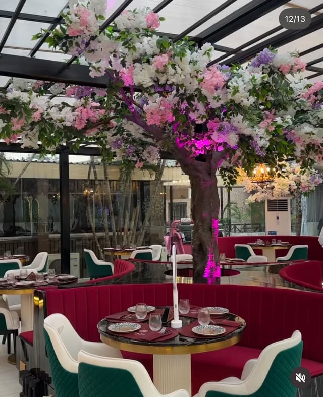 Euphoria restaurant venue with floral tree and velvet seating for upscale evening events.