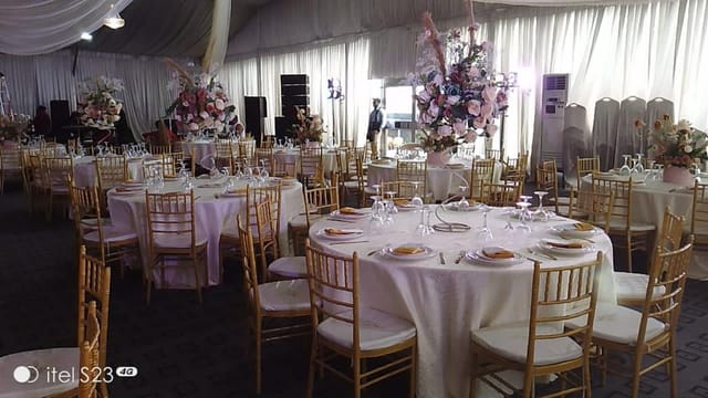 Elegant dinner theater setup at The Canyon Lekki with gold chairs for weddings and formal events.