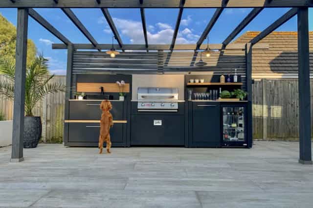 Outdoor kitchen for high-end networking event with ambient lighting and professional catering.