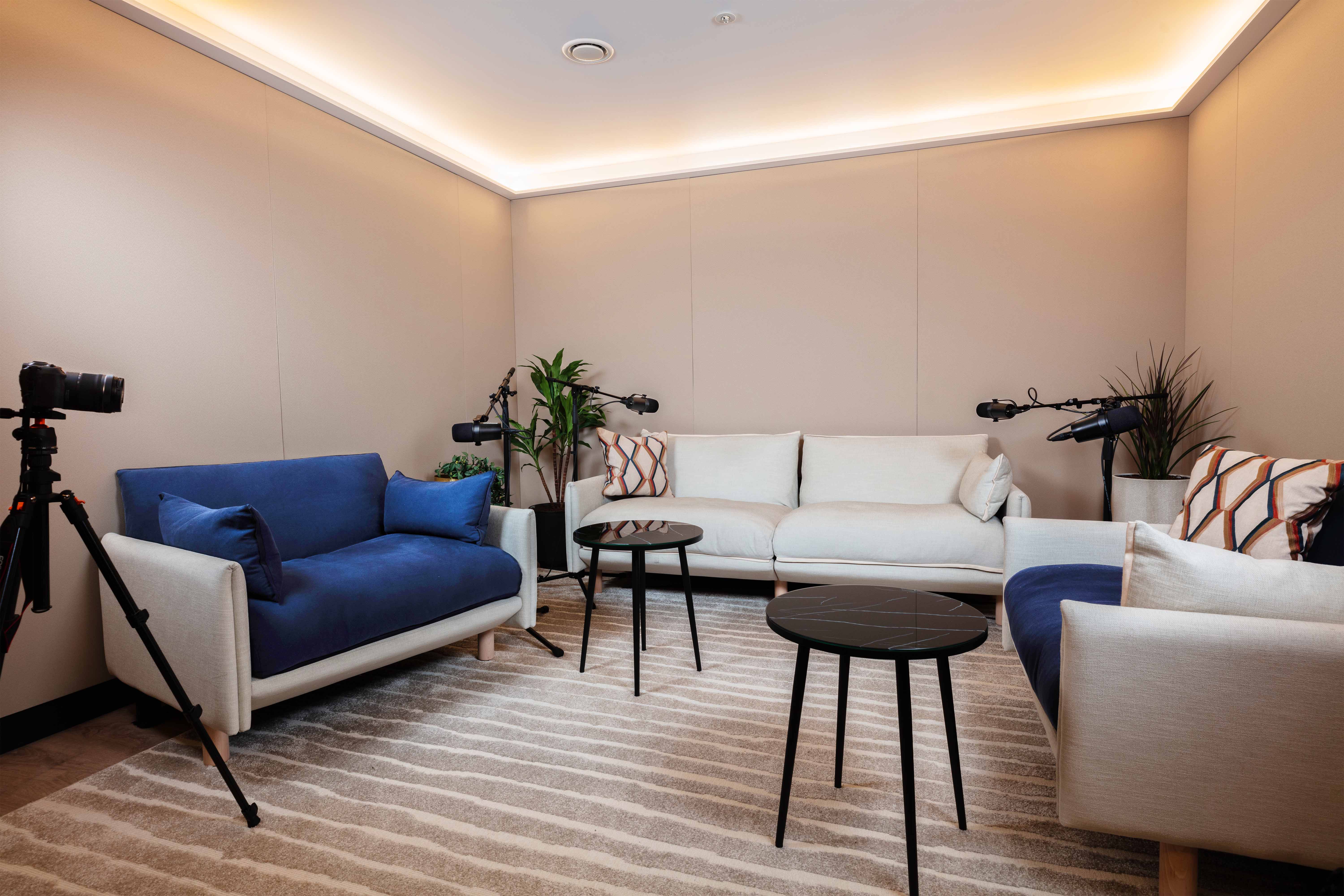 Modern podcast studio with soft lighting, ideal for interviews and live streaming.