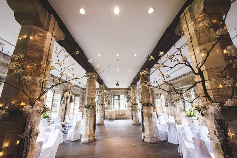 Historic Hospitium York wedding venue with aisle pillars for intimate ceremony decor.