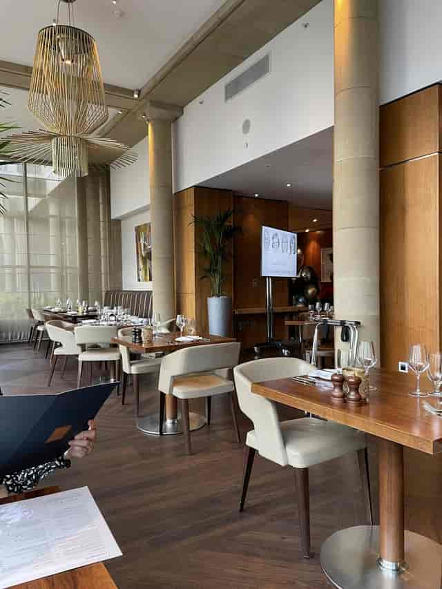 Upscale One Square Brasserie dining room with AV display for corporate dinners and VIP events.