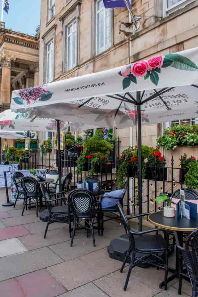 Outdoor terrace with bistro seating at Le Monde Hotel for corporate networking and breakout events.