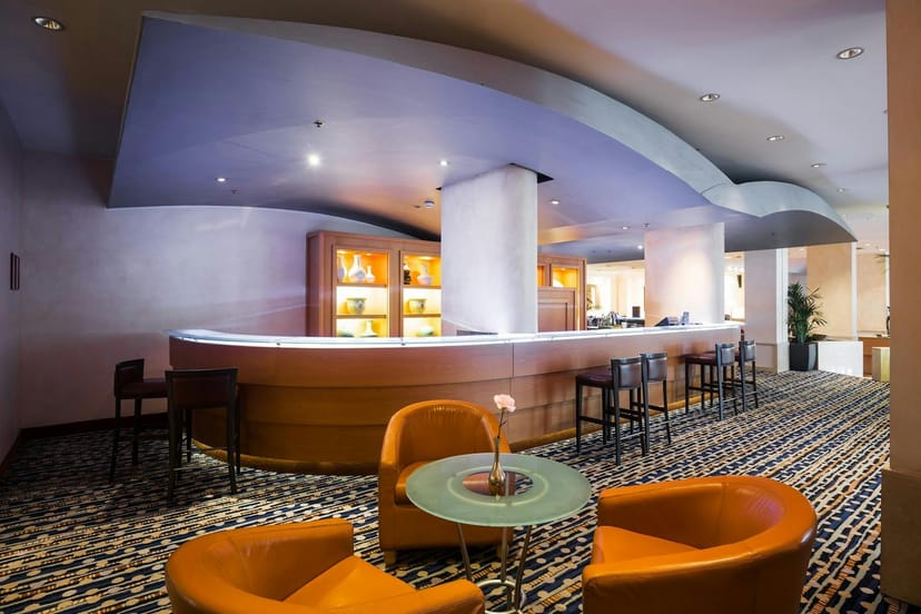 Modern Hilton Rome Airport banquet hall with bar, perfect for corporate events and networking.