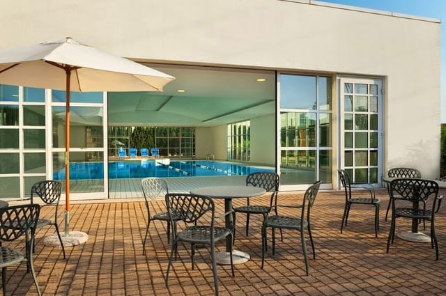 Banquet hall with poolside access at Hilton Rome Airport for corporate events and networking.