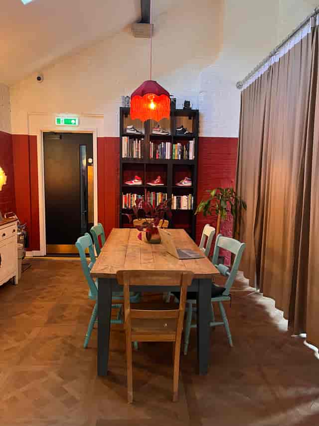 Casual breakout room with eclectic seating for creative workshops and informal team meetings.