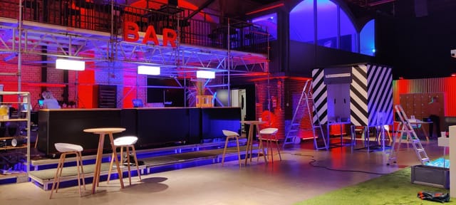 Industrial event space with tiered scaffolding for networking mixers and brand activations.