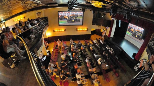 Mansfield Bar dual-screen viewing event with theater seating for broadcast activations.
