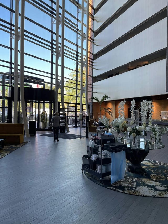 Modern hotel foyer with high ceilings, ideal for event registration and corporate breakout spaces.