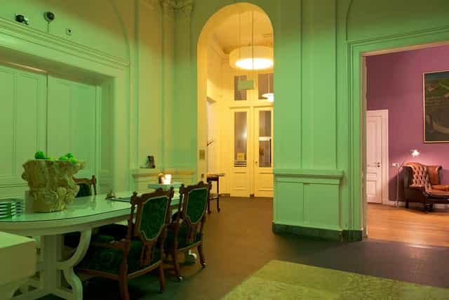 Hotel Pincoffs heritage suite with green lighting, ideal for meeting room or event space.