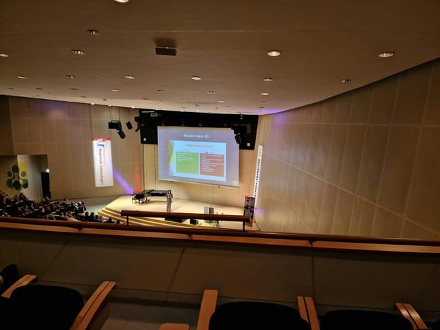 Eduard Flipse Zaal auditorium stage setup for corporate event presentation.
