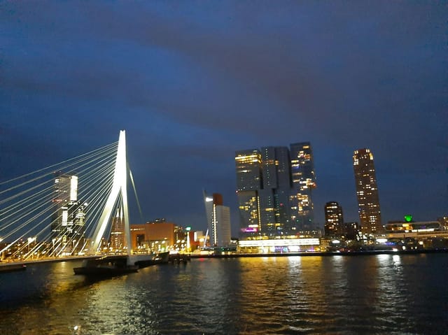 Thon Hotel Rotterdam gala dinner meeting room with panoramic Erasmus Bridge city skyline view.