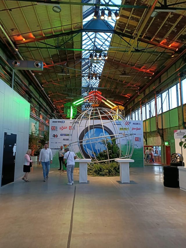 Industrial exhibition space at RDM Onderzeebootloods with globe decor for B2B event venue.