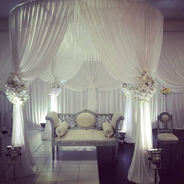 Elegant white floral wedding stage at Diamond Plaza, ideal for bridal ceremonies and receptions.
