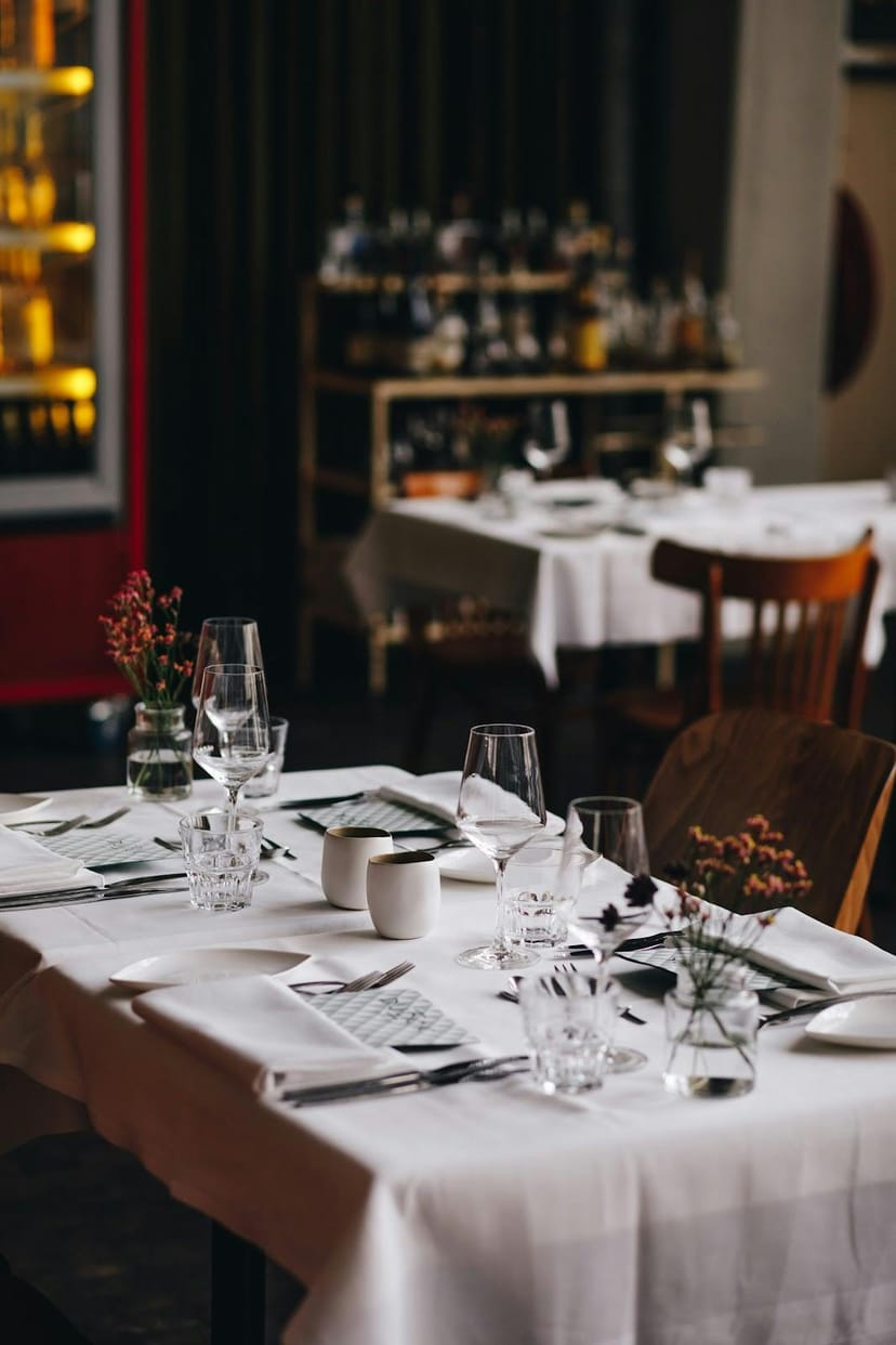 Upscale corporate luncheon banquet setup at Dudok Aan De Maas with crisp white linens.