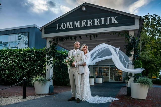 Outdoor wedding venue at Lommerrijk featuring elegant floral planters and manicured garden backdrop.