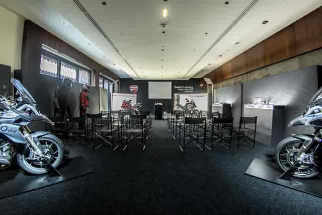 Classroom-style product launch setup with motorcycle displays at Terre Blanche boardroom.