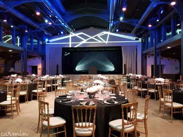 Industrial-chic gala setup with gold chiavari chairs at Pavillon Gabriel for corporate events.