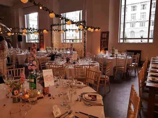 Banquet setup at Oh Me Oh My with string lights for wedding or corporate dinner events.
