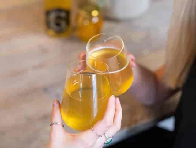 Networking event: guests making a toast with glassware at a Gosnells bar, happy hour reception.