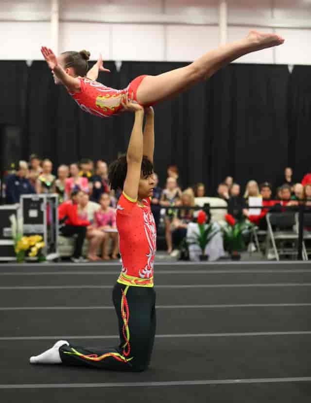 Gymnastics performance at Pennington Field with multi-tiered floor for competitive event hosting.