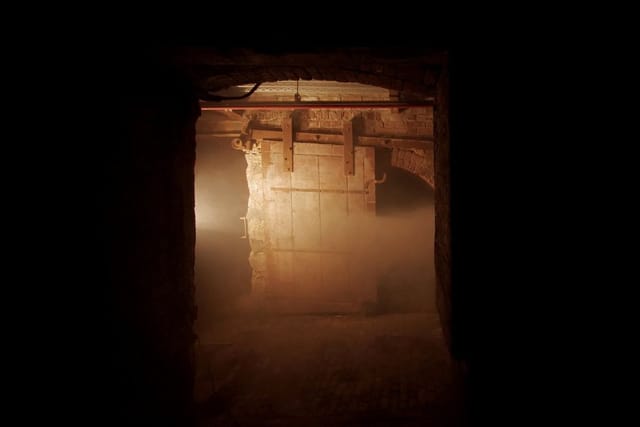 Basement nightclub entrance with dim lighting, emergency exit safety hazard, event venue violation.