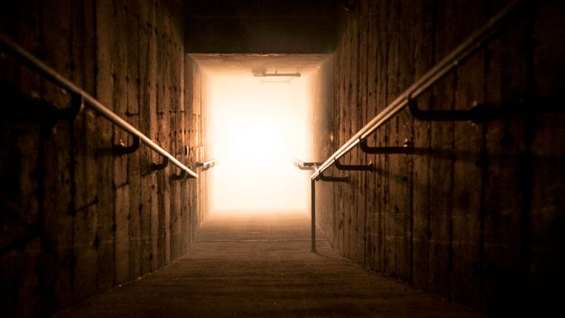 Basement nightclub entrance with poor lighting, lacking event signage and accessibility planning.