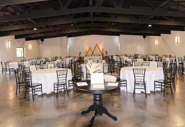 Grand Hall industrial-chic event venue with vaulted beams, ideal for banquets and corporate events.