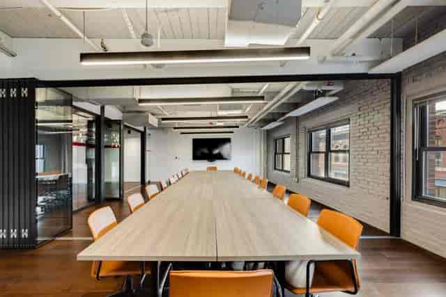 Industrial boardroom with flexible partitions for professional corporate meetings and workshops.