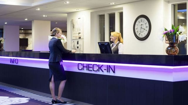 Professional hotel lobby check-in desk for event registration and delegate arrival.