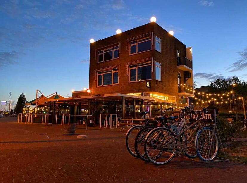 Eetcafé Verhip waterfront venue with string lighting for corporate happy hour and networking event.