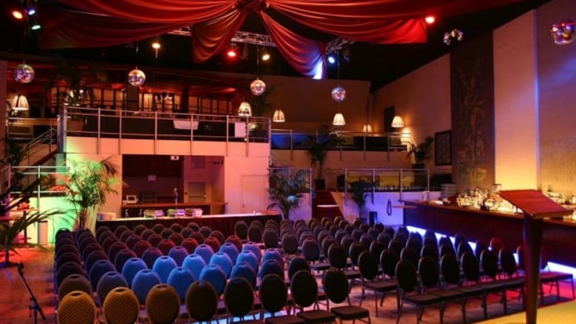 Villa Thalia event hall with red ceiling drapes, ideal for corporate mixers and awards galas.