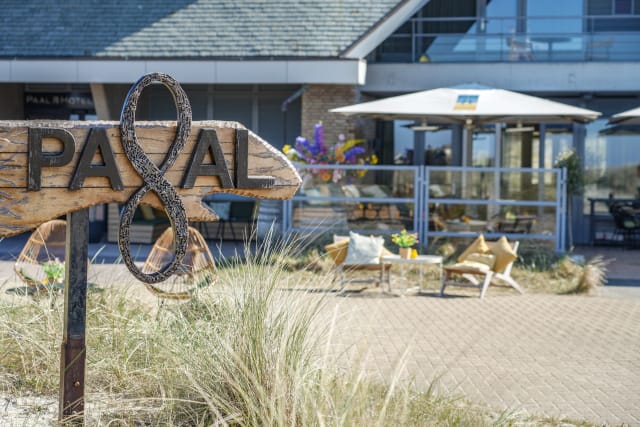 Upscale coastal hotel terrace, ideal for corporate retreat and networking break.