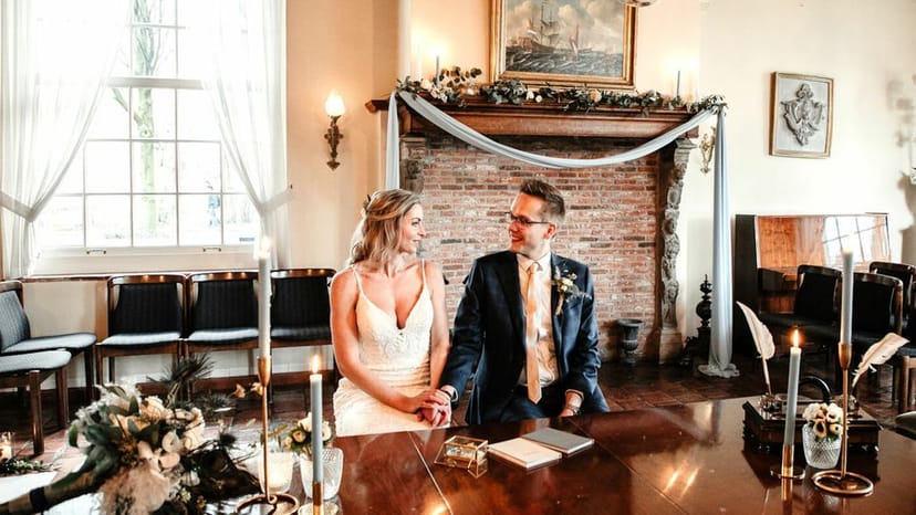 Intimate micro-wedding table for two in historic Landhuis de Oliphant with elegant drapery.