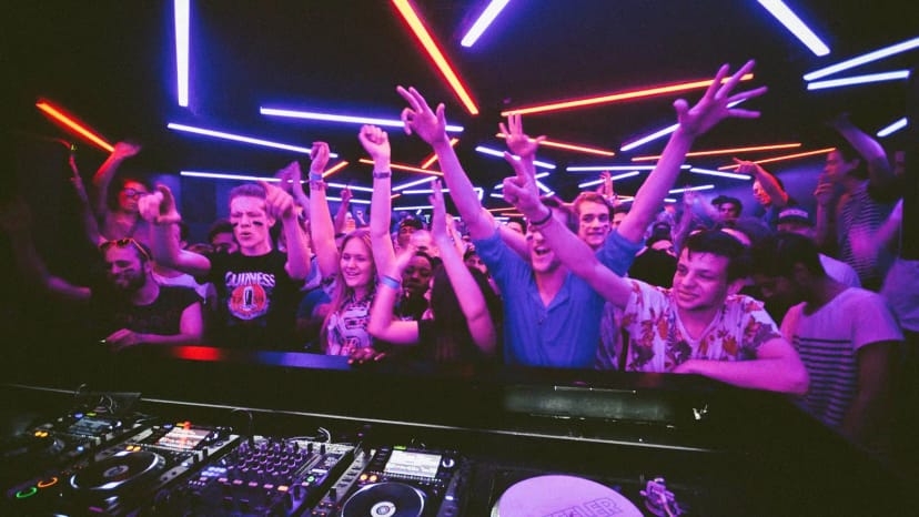Toffler nightclub DJ booth with atmospheric lighting for an energetic club event finale.