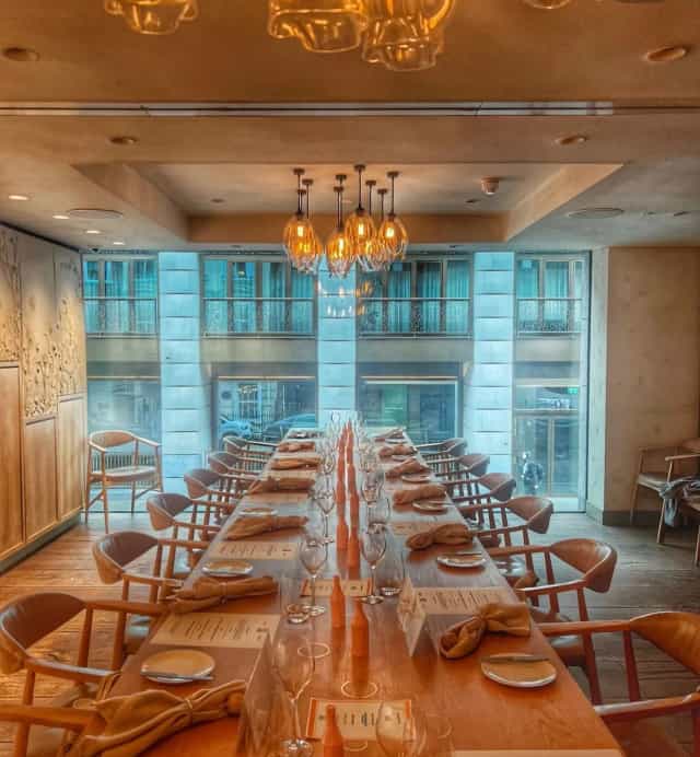 Private dining room with long table for corporate events at Hide Restaurant.