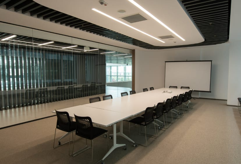 Modern boardroom with modular tables in AIFC Cambridge for corporate training and strategy sessions.