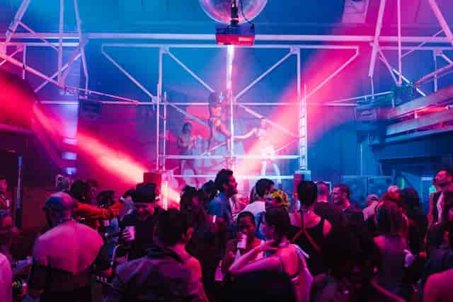 Unit 58 nightclub event with industrial scaffolding stage and vibrant dance floor lighting.