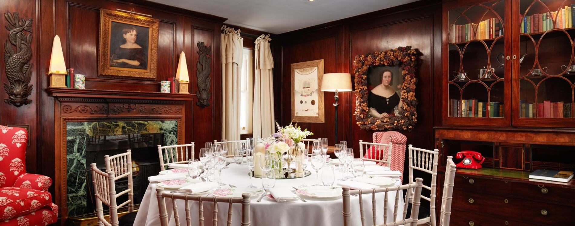 Elegant dining table in wood-paneled restaurant for upscale events and private gatherings. - Banner