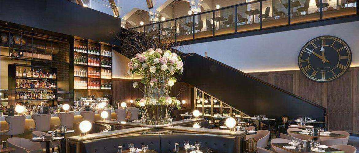 Elegant dining space at Meister Bar, perfect for upscale events with floral centerpiece. - Banner