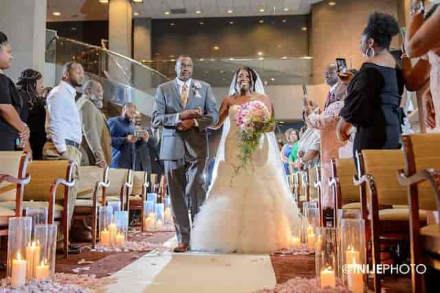 Wedding processional in Beeson Hall with floor candle lighting for formal event decor.