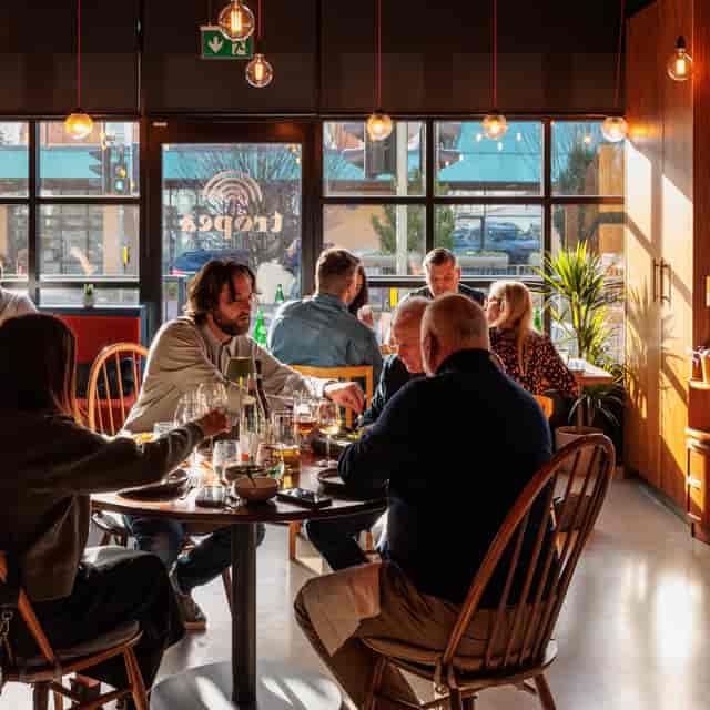 The Sage restaurant-style room with circular tables for networking dinners and corporate events.