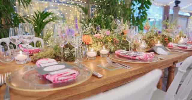 Rustic tablescape with moss and florals for boutique weddings and corporate dinners.