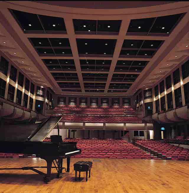 Sirote Theater stage with grand piano for corporate keynotes and formal performances.