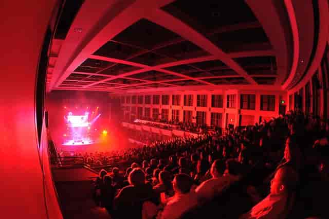 Jemison Concert Hall stage with red theatrical lighting for keynote or concert events.