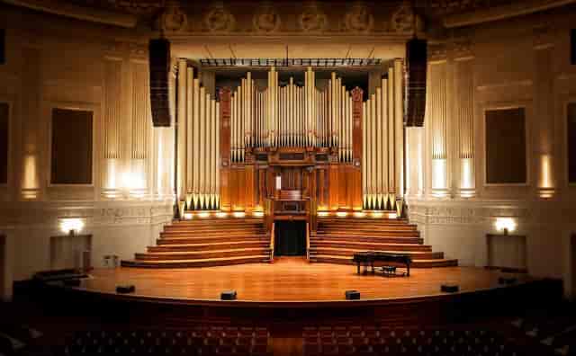 Jemison Concert Hall stage with iconic pipe organ for formal keynote or performing arts events.