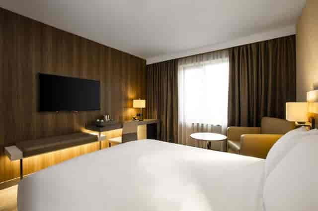 Modern hotel suite with workspace for business travel and remote work connectivity.