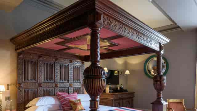 Luxurious four-poster bed in elegant Zetter Marylebone bedroom for corporate events.